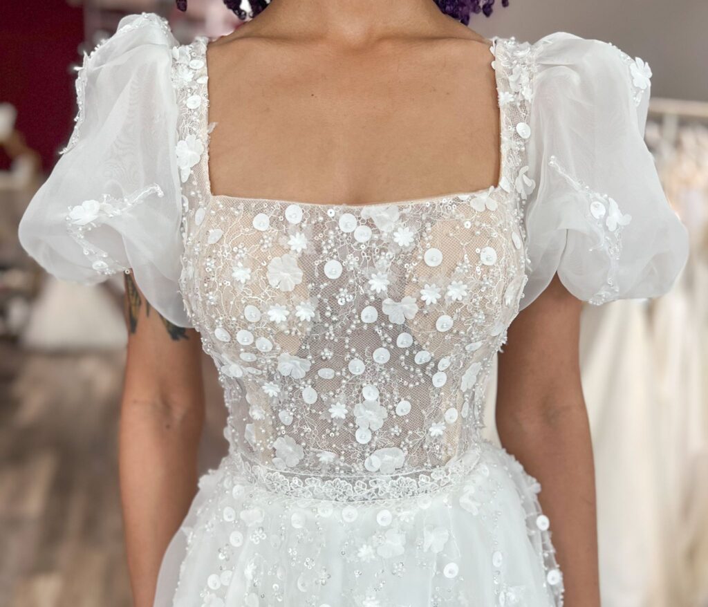 bride wearing square neckline wedding dress in off the rack bridal store Hayward california