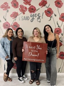 bride holding i said yes sign at wedding dress shop